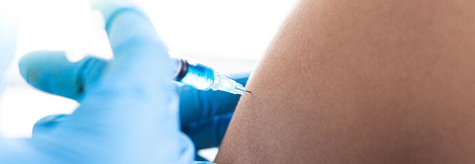 Vaccination of patients, Doctor provided a vaccine with a syringe against a new strain of  virus or influenza in a modern hospital, Prevention and health care concept.