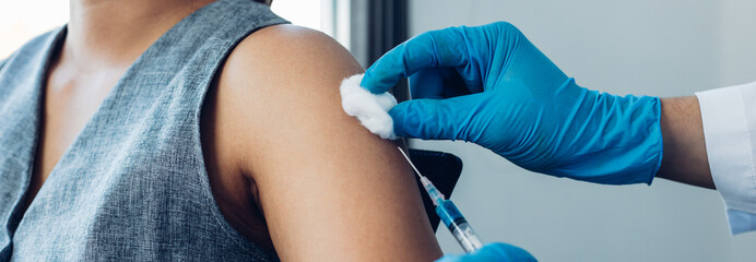 Vaccination of patients, Doctor provided a vaccine with a syringe against a new strain of  virus or influenza in a modern hospital, Prevention and health care concept.