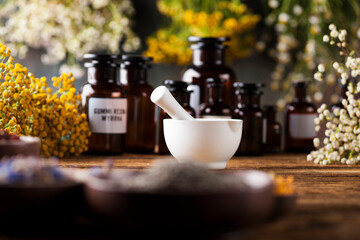 Herbs medicine,Natural remedy and mortar on vintage wooden desk background