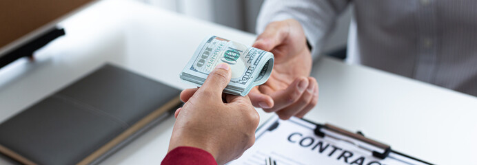 Businessmen give dollars to bribe employees in signing contracts to buy illegal land and real estate, Business fraud and social injustice, corruption and bribery concept.