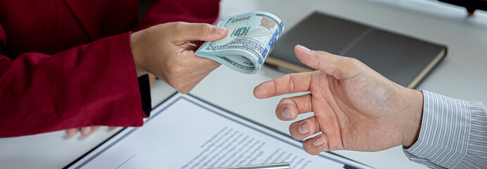 Businessmen give dollars to bribe employees in signing contracts to buy illegal land and real estate, Business fraud and social injustice, corruption and bribery concept.