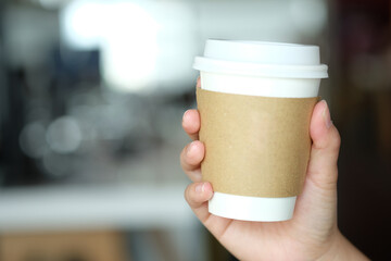 hand holding a cup of coffee