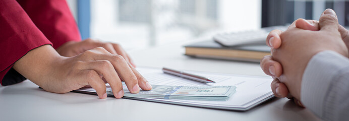 Businessmen give dollars to bribe employees in signing contracts to buy illegal land and real estate, Business fraud and social injustice, corruption and bribery concept.