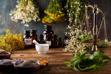 Herbs medicine,Natural remedy and mortar on vintage wooden desk background