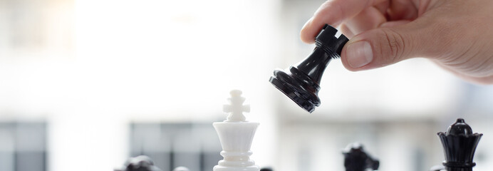Business men make plans to play chess with Prudence and success, Management or leadership concept.