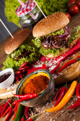 Home made burgers on wooden background..