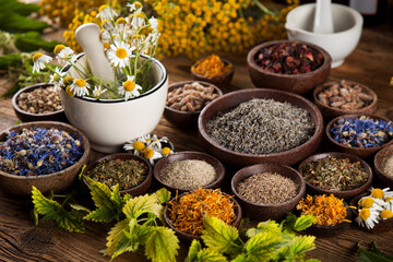 Herbs medicine and vintage wooden desk background