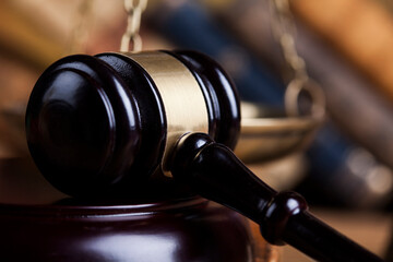 Law theme, mallet of the judge, wooden desk background