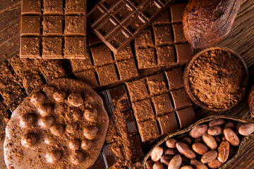 Dark homemade chocolate bars and cocoa pod on wooden