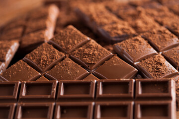 Dark and milk chocolate bar on a wooden table