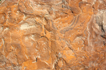 The texture of natural stone is orange with brown pigmentation