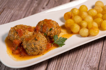 Recipe for meatballs in tomato sauce with hazelnut potatoes. High quality photo