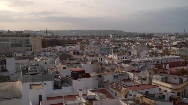 Panning across urban city of Seville with many dense houses