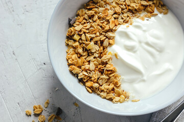 Yogurt with muesli and berries on a gray background.