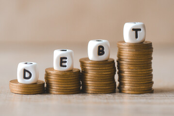 Block word debt on pile of coins, Payment of taxes and of debt to the state, Concept of financial crisis and problems risk management debt exemption loan