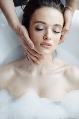 Naklejka premium Facial care and massage, young beautiful and attractive girl on cosmetic procedure