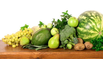 Useful green vegetables on a wooden background.