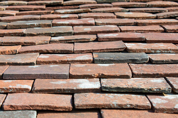 Texture and shape of old brick tiles on an ancient church in England. 