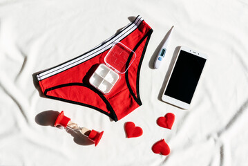 Women's underwear, stethoscope, smartphone and thermometer. Concept of women's health,...