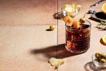Vermouth cocktail with appetizer isolated on red background with copy space. Typical spanish...