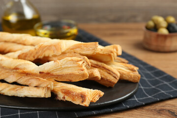 Tasty grissini on wooden table, closeup view