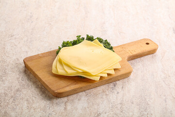 Sliced Gouda cheese over board