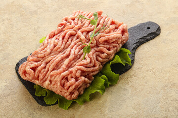 Raw minced pork meat over board
