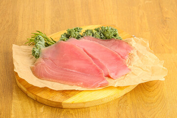 Raw salted tuna slice over board