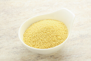 Raw couscous in the bowl