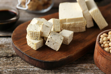 Natural tofu on wooden table, closeup. Soy product