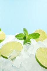 Ice with mint and lime on blue background