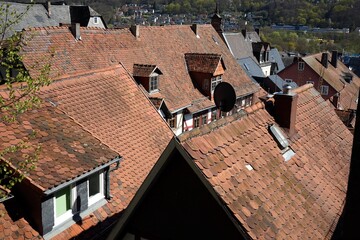 Alte rotbraune Satteldächer mit Mansarde, Dachgaube, Spitzgiebel und Satellitenschüssel im Sommer...