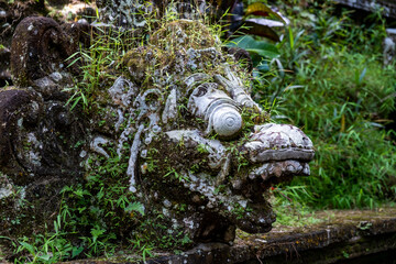 old statue of mithycal creature on bali, indonesia