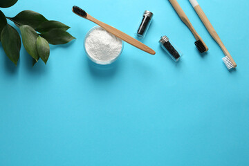 Bowl of tooth powder, brushes, dental flosses and plant on turquoise background, flat lay. Space for text