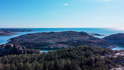 Aerial view of the sea wave and rocks of the coastline of Norway, Telavåg. Panoramic view of the rocks by the sea. The sea wave rolls along the shore. View of the sea coast from the air. Ocean space
