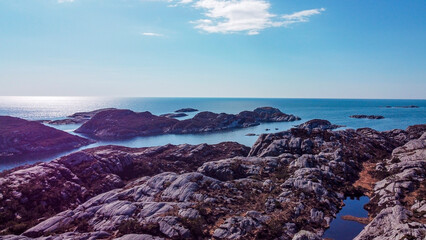 Aerial view of the sea wave and rocks of the coastline of Norway, Telavåg. Panoramic view of the rocks by the sea. The sea wave rolls along the shore. View of the sea coast from the air. Ocean space