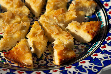 Basousa, a traditional Central European dessert. Adapted to a low-carb ketogenic diet, the cake is made with almond and coconut flour, a sweetener, and garnished with almond flakes.