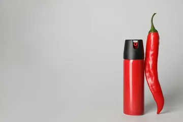 Fotobehang Chili Pepers Bottle of gas spray and fresh chili pepper on light grey background. Space for text  © New Africa