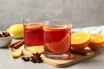 Aromatic punch drink and ingredients on grey table