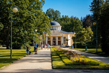 Frantiskovy Lazne, Western Bohemia, Czech Republic, 14 August 2021: Colonnade or Hall of Glauber's Springs, White and yellow baroque columns at park, spa town Franzensbad at sunny summer day