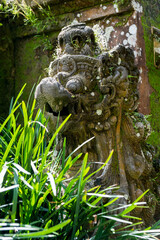 old statue of mithycal creature on bali, indonesia