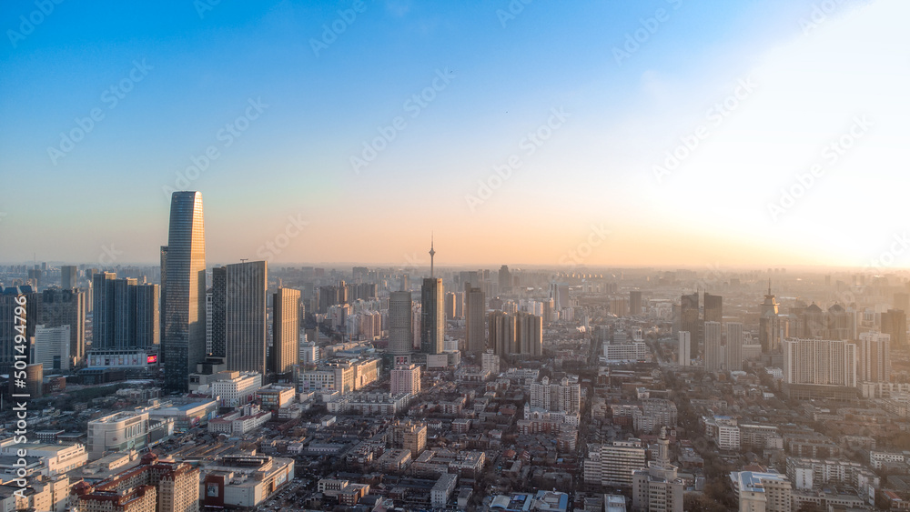 Poster panorama of a cityscape with modern buildings at sunrise and clear sky