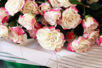 Thriving of full bloom flowerscape, floral visual of live flowers wall, beautiful roses background. Front top photo of a pink roses with selective focus in a bouquet on a soft green background 