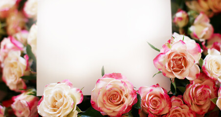 Wedding, birthday stationery mock-up scene. Blank paper greeting card, invitation. Decorative floral composition. Closeup of pink roses petals. Mock up with empty space.