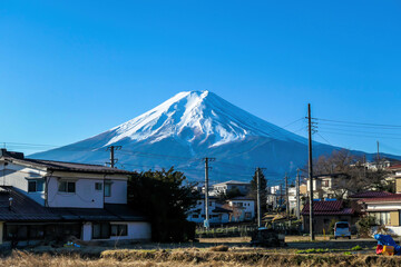 Mt Fuji towering above the Fujiyoshida city, seen from the city level. The mountain is positioned...