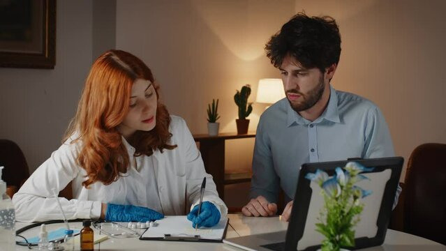 Italian female doctor girl prescribes medicines to boy patient in the clinic.