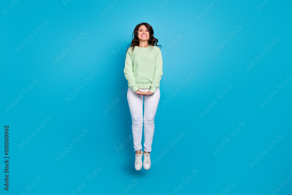 Poster Full size photo of sweet mature brunette lady jump wear shirt pants shoes isolated on blue background