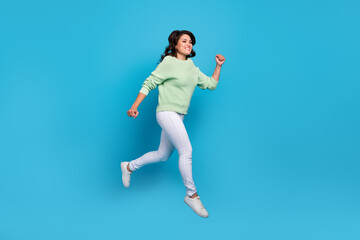 Fototapeta na wymiar Full body photo of cute mature brunette lady run wear shirt pants footwear isolated on blue background