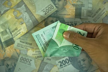 Dua puluh ribu rupiah, translate 20000 IDR, Indonesia rupiah money concept was helad by businessman...