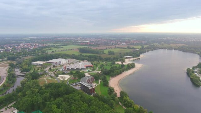 Wolfsburg, Germany: Aerial view of city in Lower Saxony, lake Allersee in morning - landscape panorama of Europe from above